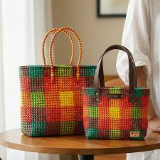 Handwoven plastic wire tote bags in multicolor check pattern with sturdy handles placed on table