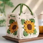 Handmade crochet sunflower handbag with granny square design in cream, yellow and green colors