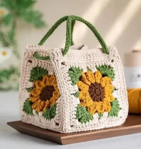 Handmade crochet sunflower handbag with granny square design in cream, yellow and green colors