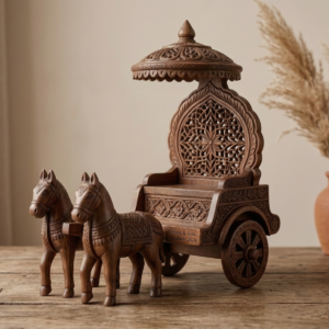 Handcrafted wooden chariot showpiece with carved horses and decorative canopy placed on wooden table