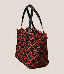Handwoven plastic wire tote bag in black and red floral pattern with shoulder straps
